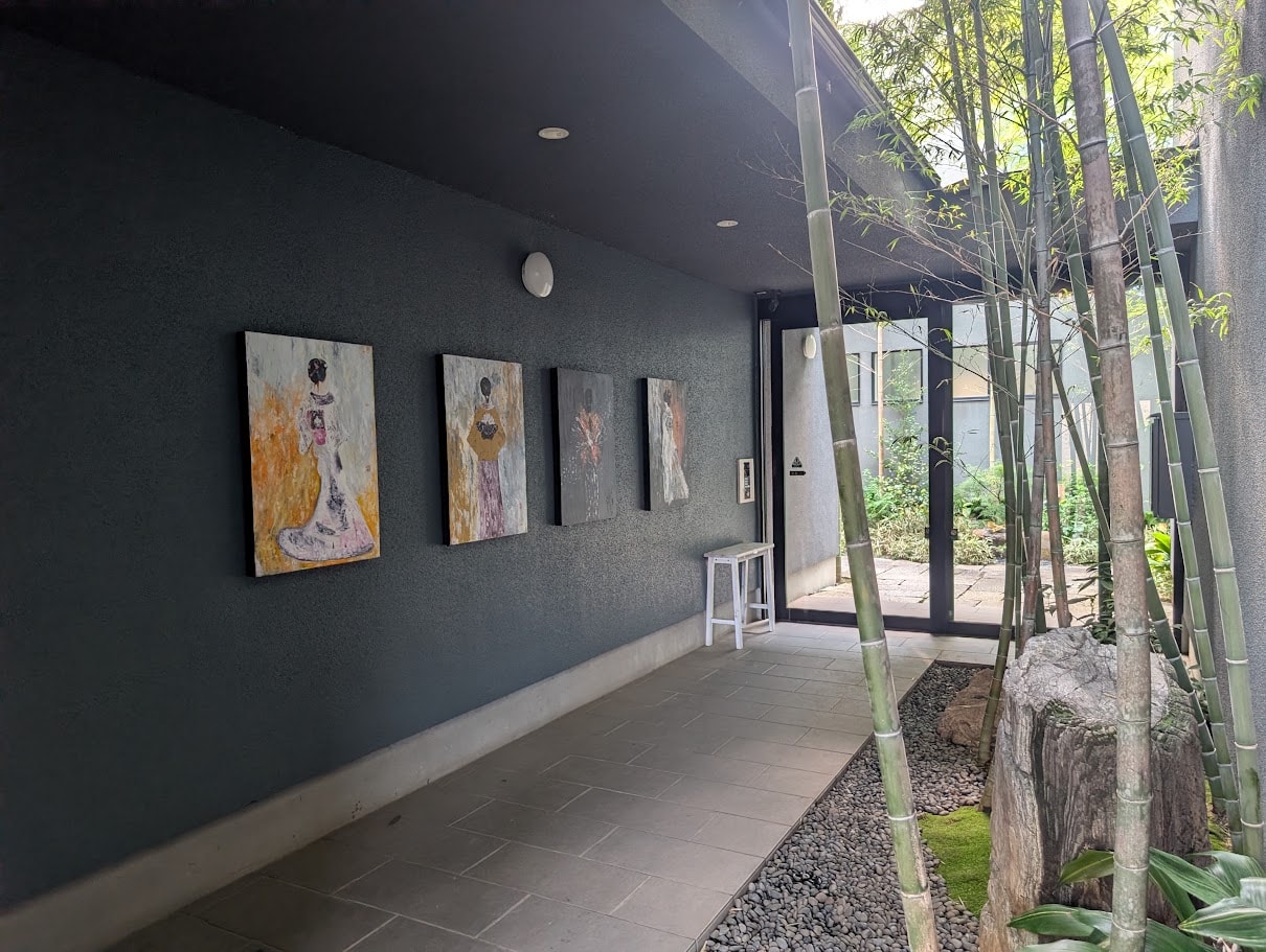 Bamboo House entrance corridor with art, bamboo and stone